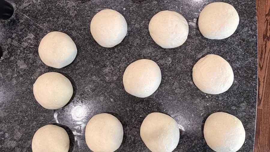 A fresh batch of hand-portioned J Mo dough balls resting before wrapping