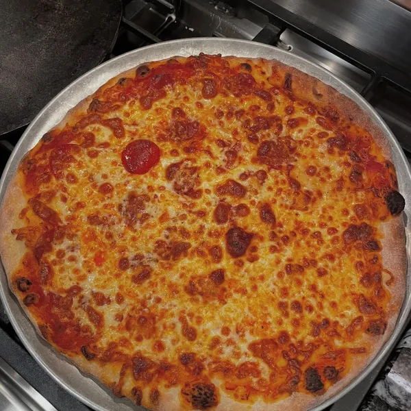 Bubbly pepperoni and cheese pizza fresh from the oven on a round pan