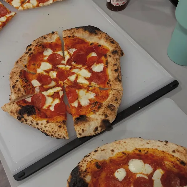 Neapolitan-style pepperoni pizzas with fresh mozzarella and charred crust