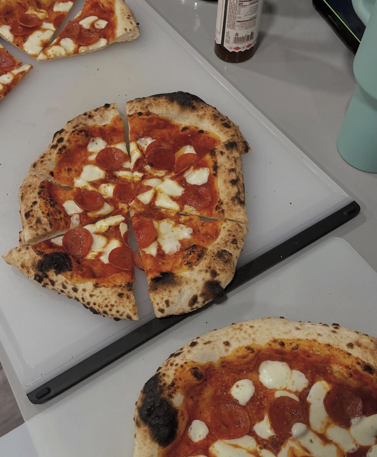 Neapolitan-style pepperoni pizzas with fresh mozzarella and charred crust